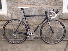 a bike parked in front of a stone wall