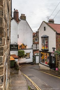 the narrow street is lined with buildings and shops