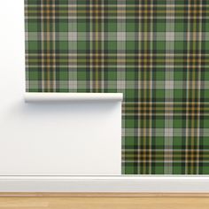 a green and yellow plaid wallpaper in an empty room