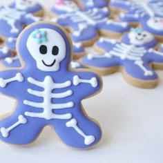 decorated cookies in the shape of skeletons on a table