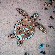 a wooden cutout of a turtle on the ground