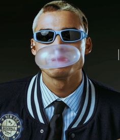 a man with glasses and a fake bubble coming out of his mouth is wearing a police uniform