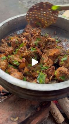 a pan filled with food sitting on top of a wooden table