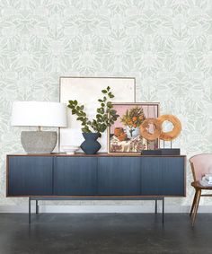 a sideboard with two vases and a lamp on top