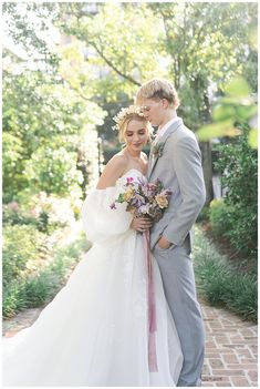 a bride and groom pose for a wedding photo