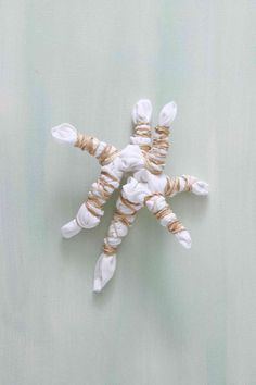 a white and brown rope wrapped snowflake ornament