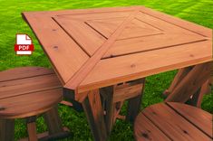 a wooden table and two stools in the grass