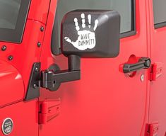 a red jeep with a hand print on the side mirror