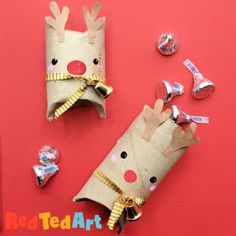 paper roll reindeer craft for kids on red background with candy candies and confetti