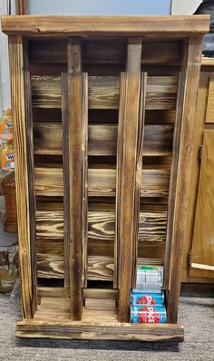 a wooden cabinet with several compartments and shelves