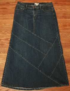 a pair of jeans sitting on top of a wooden floor