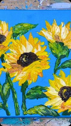 a painting of yellow sunflowers on a blue background