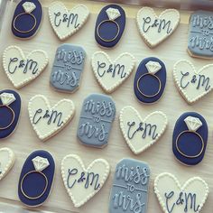 decorated cookies in the shape of hearts with wedding rings and engagement rings on them that say i am engaged