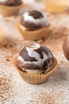 chocolate cupcakes with white frosting and sprinkles