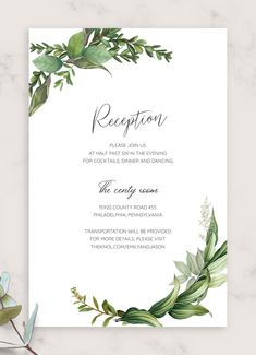 an elegant wedding reception card with greenery