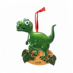 a christmas ornament with a green dinosaur on it