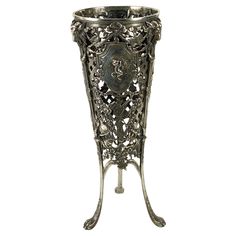 an ornate metal vase on a stand