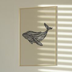 a drawing of a whale is hanging on the wall