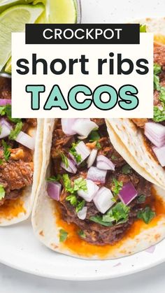 three short ribs tacos on a white plate with limes and cilantro