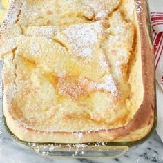 a baked dish with powdered sugar on top