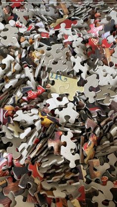 a pile of puzzle pieces that have been placed on top of each other