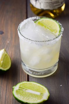 a margarita cocktail with limes on the side