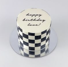 a black and white birthday cake with the words happy birthday love written on it