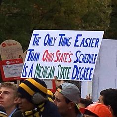 a group of people holding up signs in the air