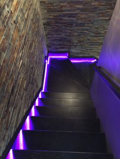 the stairs are lit up with purple lights