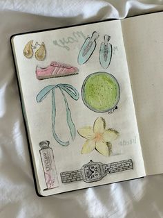 an open notebook with various items drawn on the pages, including shoes and other things