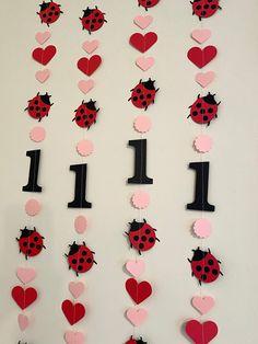 the number one is made out of paper with ladybugs and hearts on it