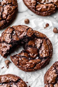 a chocolate cookie doughnut is cut in half and placed on top of white paper