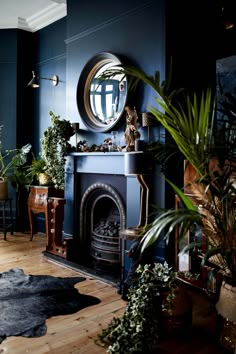 a living room filled with furniture and a fire place under a round mirror on the wall