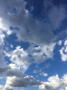 an airplane is flying in the sky with clouds