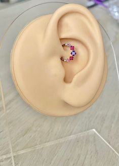 a pair of earrings sitting on top of a plastic container