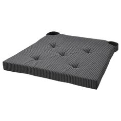 a mattress that is made out of grey fabric and has buttons on the bottom side