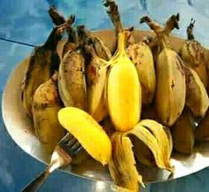 a bunch of bananas sitting on top of a white plate