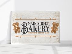 a sign that says main street bakery with gingerbread cookies and teddy bears on it