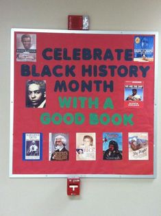 a red bulletin board with black history month written on it and various books attached to the wall