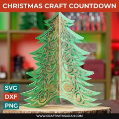 a green christmas tree cutout sitting on top of a piece of wood with the words christmas craft countdown below it