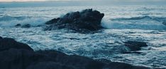 waves crashing on rocks in the ocean