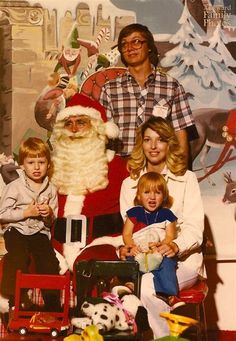 a family poses for a christmas photo with santa