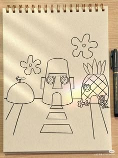 a drawing of a robot and pineapple on a piece of paper with a pen next to it