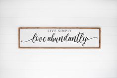 a wooden sign that says live simply love abundantly on the side of a wall