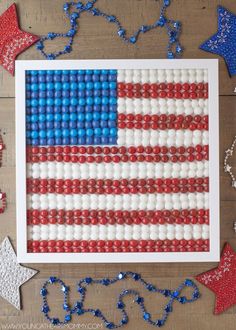 an american flag made out of beads on a wooden table next to other patriotic decorations