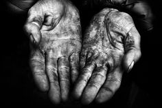 two hands that are holding something in their palms and the other hand is covered with mud