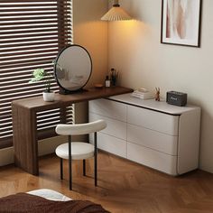 a bedroom with a desk, mirror and chair in it's corner area next to a window