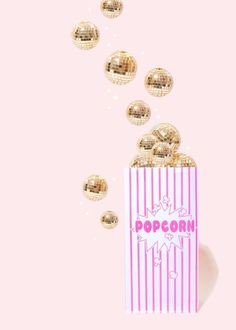 a pink and white popcorn bag surrounded by shiny gold balloons on a pink background with the words popcorn