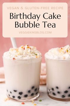 two glasses filled with bubble tea and topped with whipped cream, sprinkles