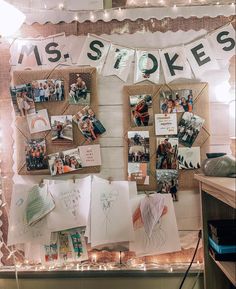 a bulletin board with pictures and lights on it